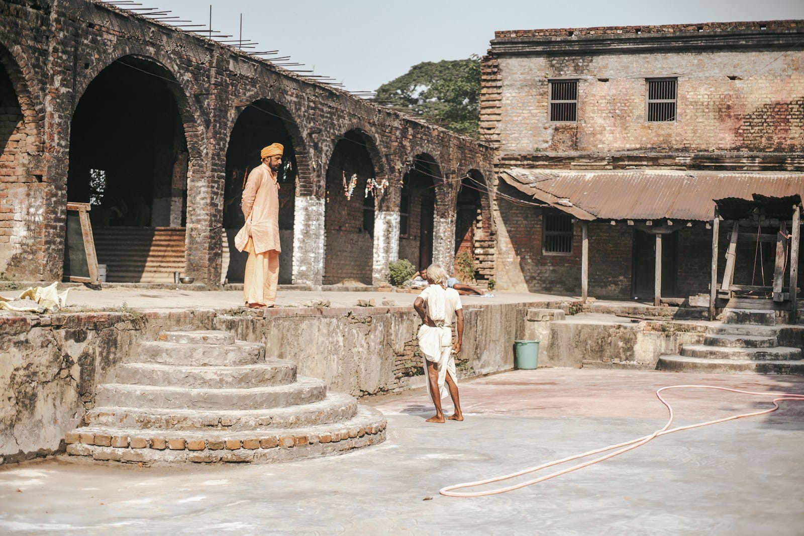 a man standing next to a child in a courtyard