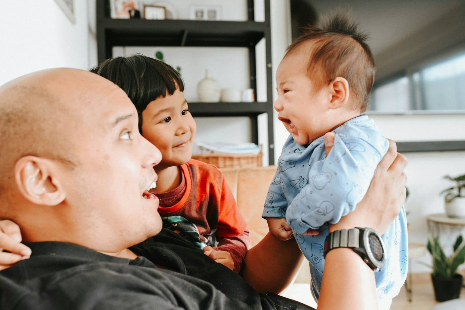 a man holding a baby up to his face